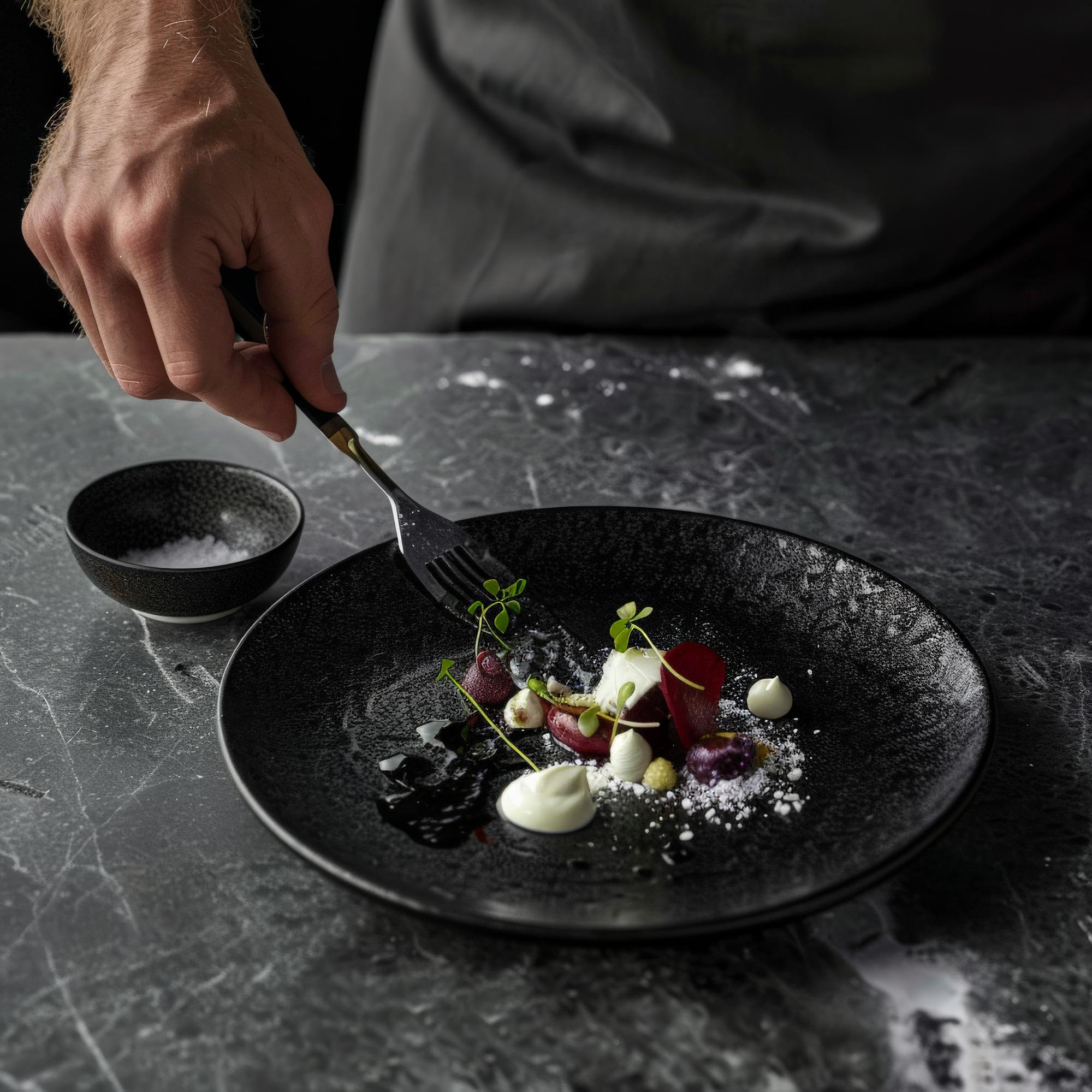 plating stylish dish on dark plate